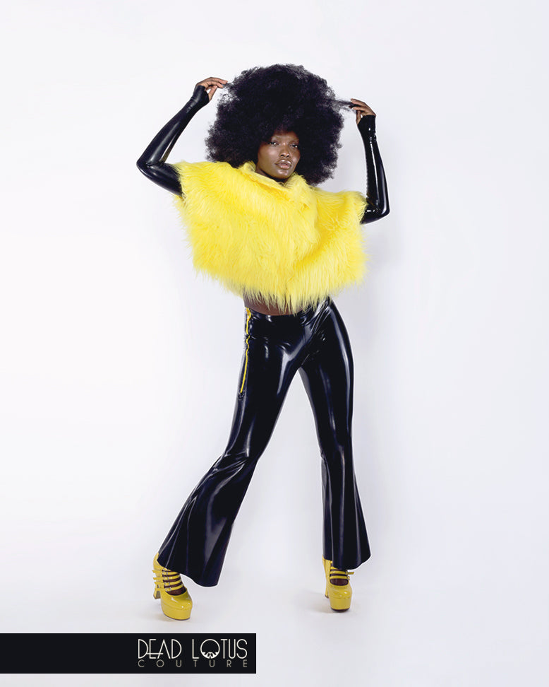 BESTIA black latex bell bottom trousers with hip zippers worn with yellow Fur Top by Dead Lotus Couture on female model