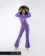 Purple latex trousers with high waist, large buttons, sharp front creased bell bottoms by Dead Lotus Couture on female model