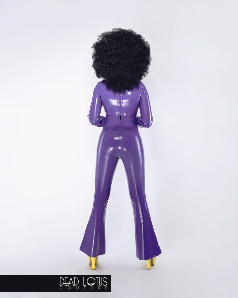 Purple latex trousers with high waist, large buttons, sharp front creased bell bottoms by Dead Lotus Couture on female model